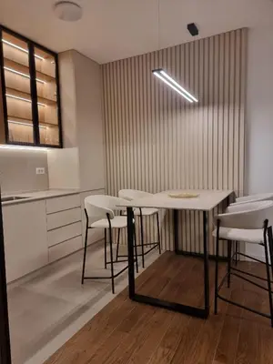 a dining room with a table and some chairs at Skyline Lux Apartment by Planet Residence in Niš