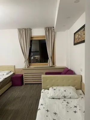 a hotel room with a bed and a window at Angela 103 in Kopaonik