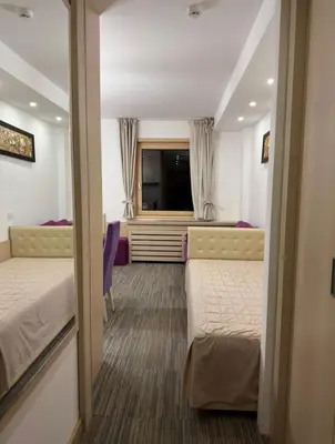 a hotel room with two beds and a television at Angela 103 in Kopaonik