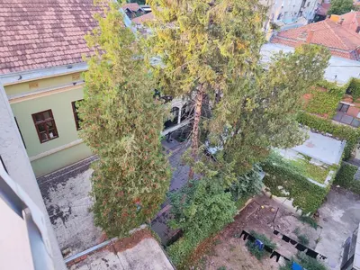 an overhead view of trees in front of a building at Konstantin Apartment in Niš