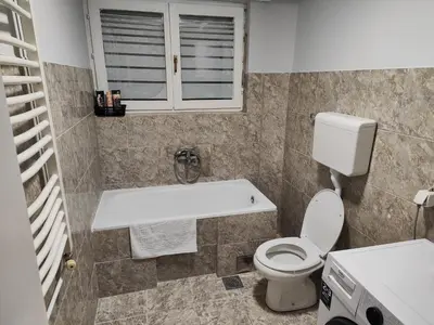 a bathroom with a toilet and a sink at Konstantin Apartment in Niš