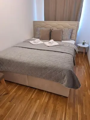 a bed with two towels on it in a bedroom at Apartman Eva in Vrnjačka Banja