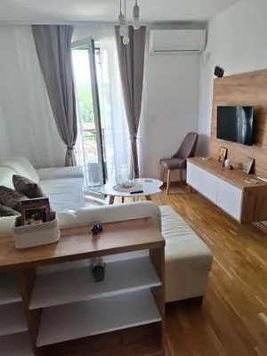 a living room with a couch and a table at Apartman Eva in Vrnjačka Banja