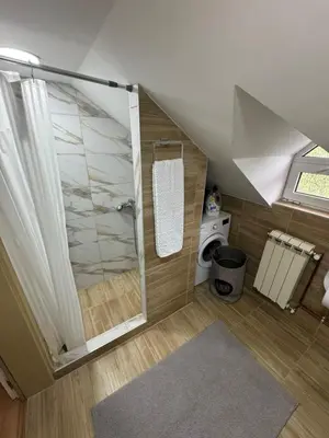 a bathroom with a shower with a glass door at Prostran moderan apartman110 kvadrata u centru- 2 spavaće sobe, parking u dvoristu in Jagodina