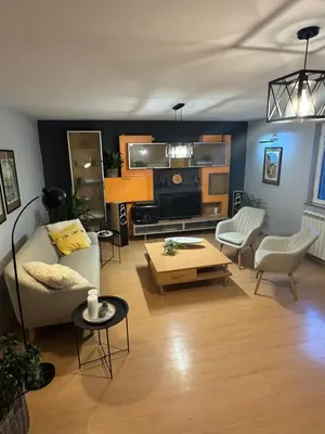 a living room with a couch and a coffee table at Prostran moderan apartman110 kvadrata u centru- 2 spavaće sobe, parking u dvoristu in Jagodina