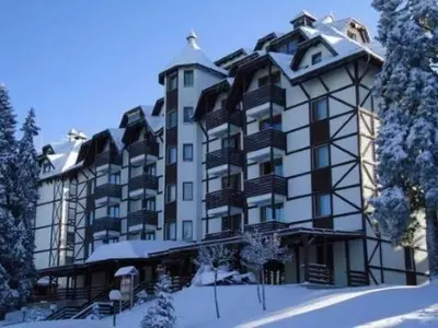 a large apartment building with snow on the ground at Cozy Bianca Studio in Kopaonik