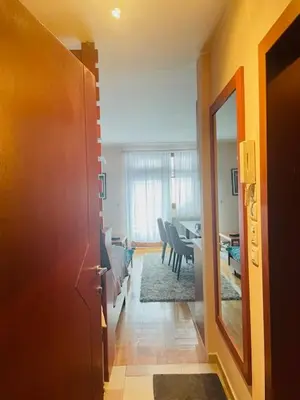 a hallway with a room with a table and chairs at Cozy Bianca Studio in Kopaonik