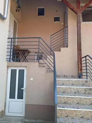 a building with a staircase with a white door at Smeštaj Golubica 5 in Soko Banja