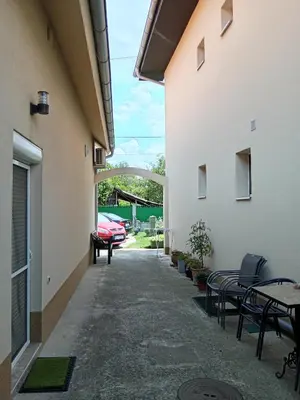a courtyard with tables and chairs in a building at Smeštaj Golubica 5 in Soko Banja