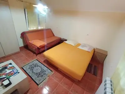 a living room with a couch and a chair at Smeštaj Golubica 5 in Soko Banja