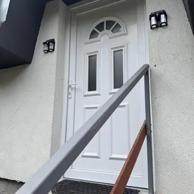 a white door on the side of a house at Apartmani Jovca in Aleksinac