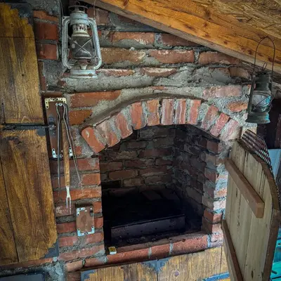 an old brick oven with a door and lights at Apartmani Jovca in Aleksinac