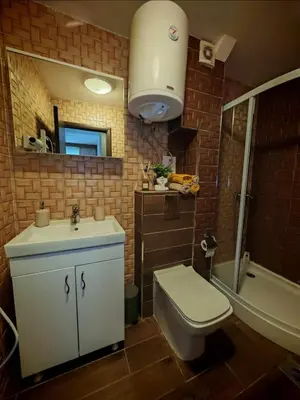 a bathroom with a sink and a toilet and a tub at Magic Apartman Kop - Kraljevi Cardaci in Kopaonik