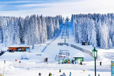 a snow covered ski slope with a ski lift at Magic Apartman Kop - Kraljevi Cardaci in Kopaonik
