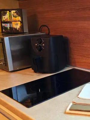 a toaster oven sitting on top of a counter at Magic Apartman Kop - Kraljevi Cardaci in Kopaonik
