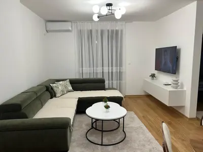 a living room with a couch and a table at Maya 2 apartman sa dve spavace sobe in Vrnjačka Banja