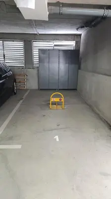 a garage with a garage door and a yellow ramp at Apartman Nik Brzeće Kopaonik in Brzeće