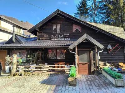 a wooden building with a sign on the front of it at Apartman Nik Brzeće Kopaonik in Brzeće