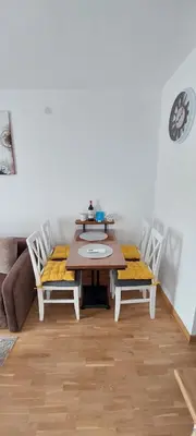 a dining room with a table and two chairs at Apartman K2 in Vrnjačka Banja