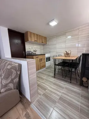 a kitchen with a table and a dining room at Šumski mir in Despotovac