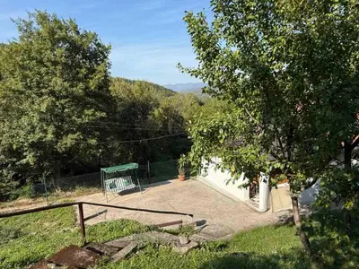 a house with a basketball hoop in a yard at Šumski mir in Despotovac