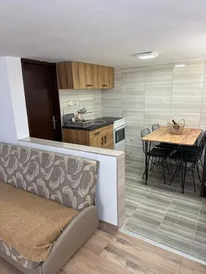a kitchen and dining room with a table and chairs at Šumski mir in Despotovac