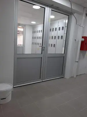 a bathroom with a toilet and sliding glass doors at Bili 3 in Paraćin