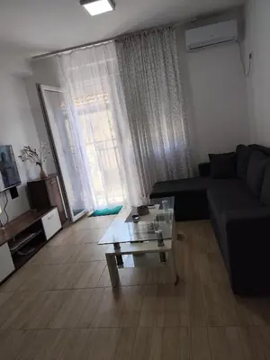 a living room with a couch and a glass coffee table at Bili 3 in Paraćin