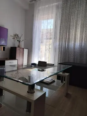 a glass table in a living room with a window at Bili 3 in Paraćin