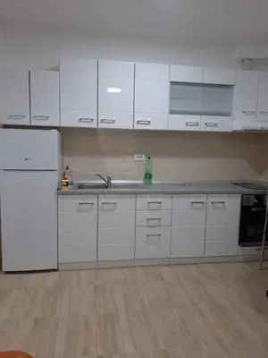 a kitchen with white cabinets and a white refrigerator at Bili 3 in Paraćin