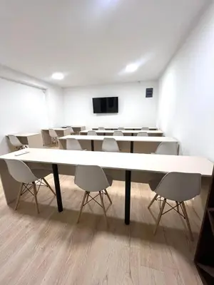 a conference room with a large white table and chairs at Talia in Niš