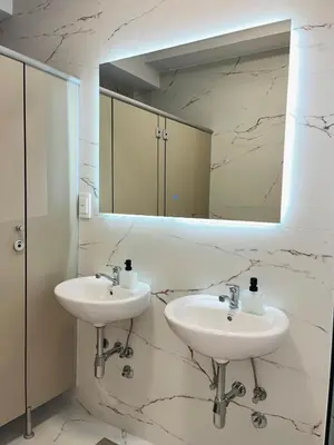a bathroom with two sinks and a mirror at Talia in Niš