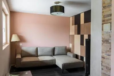 a living room with a couch in a room at The Sunny Peach in Niš
