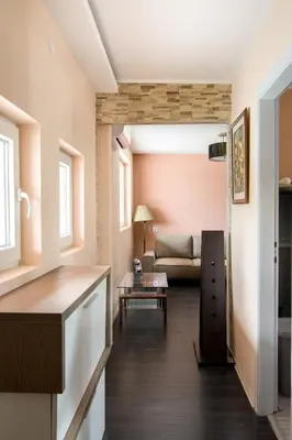 a living room with a couch and a table at The Sunny Peach in Niš