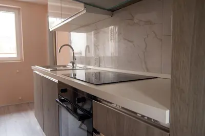 a kitchen with a sink and a counter top at The Sunny Peach in Niš