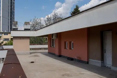 a building with a bench next to a building at The Sunny Peach in Niš