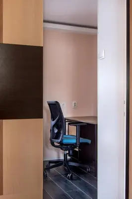 a black chair in a room with a desk at The Sunny Peach in Niš