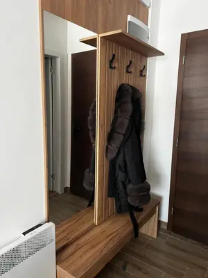 a mirror in a wooden cabinet with faux fur at Residence Hill A84 in Kopaonik