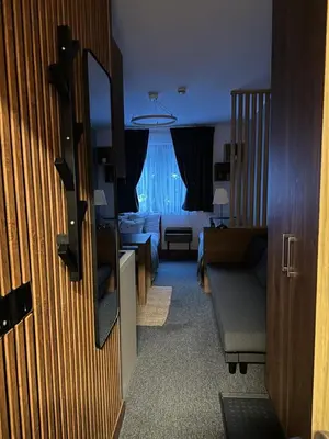 a room with a living room with a couch and a living room at Riverside Apartmani Kopaonik in Brzeće