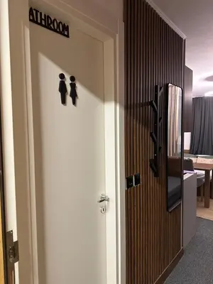 a door in a room with a sign on it at Riverside Apartmani Kopaonik in Brzeće