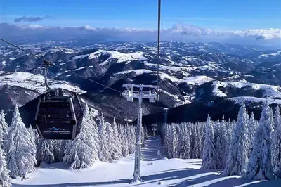 a ski lift going up a snow covered mountain at Riverside Apartmani Kopaonik in Brzeće