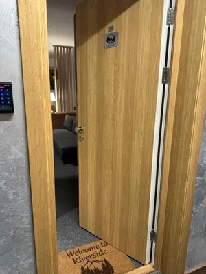 a wooden door with a sign on it at Riverside Apartmani Kopaonik in Brzeće