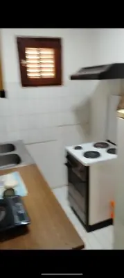 a kitchen with a stove and a counter top at Ivanka Apartmani in Bukorovac