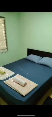 a blue bed with a towel on top of it at Ivanka Apartmani in Bukorovac