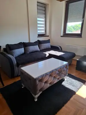 a living room with a couch and a coffee table at Queen delux in Niš