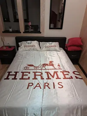a bed with the words herine paris on it at Queen delux in Niš