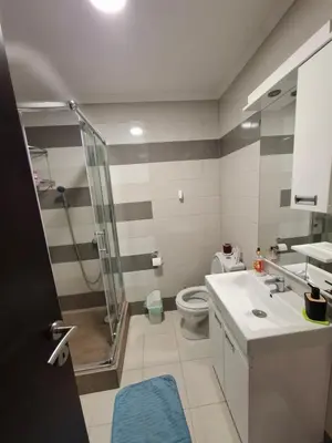 a bathroom with a shower and a toilet and a sink at Queen delux in Niš
