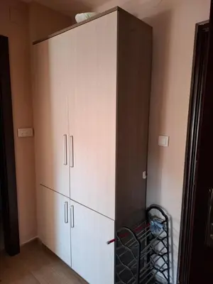 a large white cabinet in the corner of a room at Queen delux in Niš