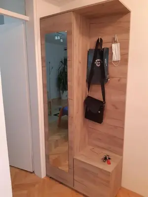 a room with a wooden door with a bag on it at M&Z Apartments in Niš