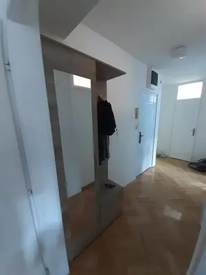 a hallway with a mirror and a door in a room at M&Z Apartments in Niš